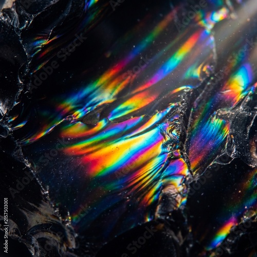 Abstract Rainbow Light Waves Crossing Black Stone Texture 
