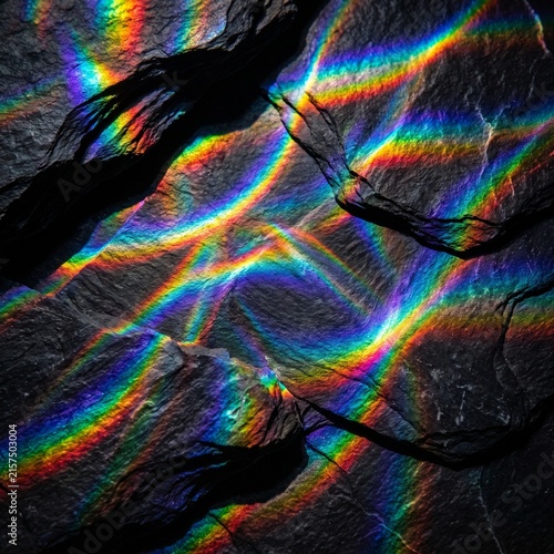 Abstract Rainbow Light Waves Crossing Black Stone Texture 