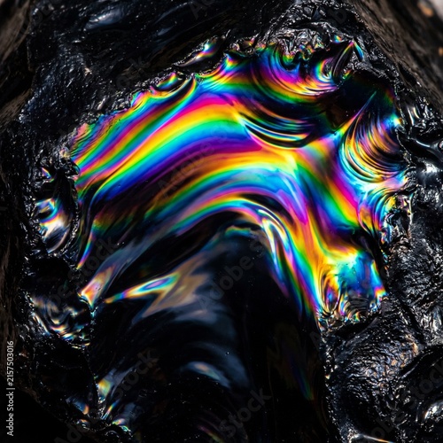 Abstract Rainbow Light Waves Crossing Black Stone Texture 