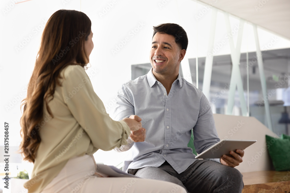 Fototapeta premium Businesspeople handshaking during meeting in coworking, as successful teamwork on joint task or project completion, starting business partnership, concluding agreement, negotiation in corporate office