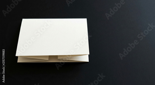 Blank Folded Paper Card Placed On Dark Smooth Surface