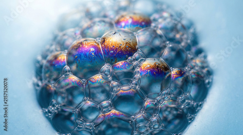 Iridescent Soap Bubbles Clustered on Light Blue Background