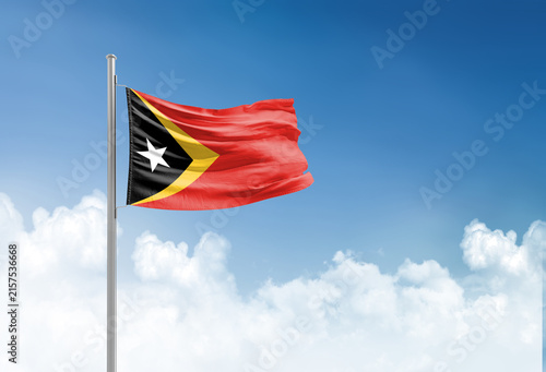 East Timor flag waving in beautiful sky.