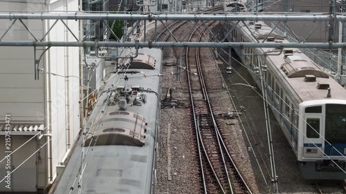 Tokyo Scene  :  Overhead View of a Commuter Train Leaving the Terminal, Clearly Showing the Pantograph and Rooftop Details  |  Ikebukuro, Tokyo, Japan