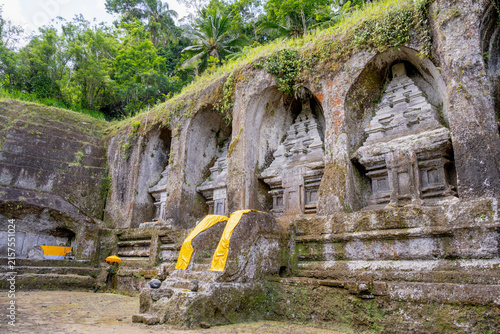 фотографія BALI, INDONESIA – OCTOBER 20, 2024: Ancient 11th-century rock-cut candi shrines carved into the cliff face at Gunung Kawi Temple