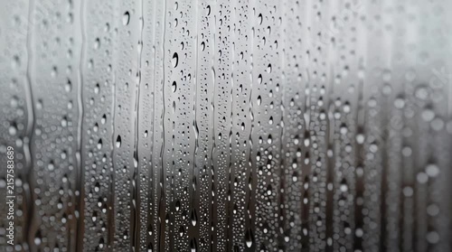 High resolution macro texture of water drops on window glass during rainy weather