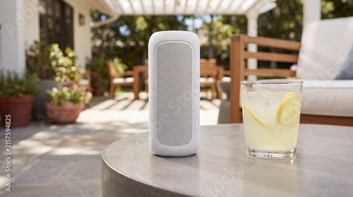 Modern Smart Wireless Bluetooth Speaker on Table with Cold Lemonade Glass