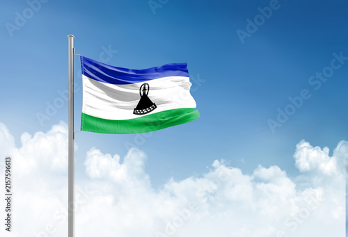 Obraz na płótnie Lesotho flag waving in beautiful sky.