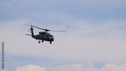 Military MH-60R Seahawk Helicopter Flying Against a Cloudy Sky