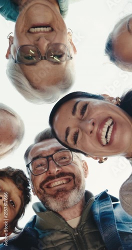 Below, face and family in nature with smile, love and bonding together on holiday reunion. Portrait, parents and grandparents outdoor with child, people and generations gathering on vacation getaway