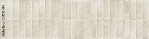 Beige white vertical finger ceramic tiles arranged in a grid backsplash pattern