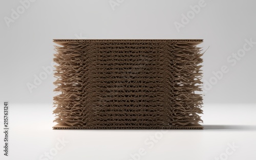 Layered brown corrugated cardboard block with frayed edges on neutral studio background for eco friendly packaging concept.