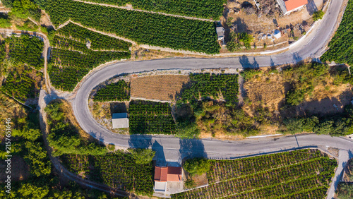 Top down aerial view of asphalt road curve in the countryside