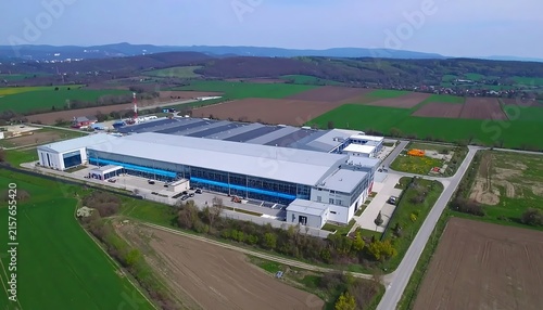 Aerial view of modern industrial facility with solar panels.