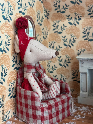 mouse doll sitting in chair in cozy room, christmas decor, banner, concept of holiday, toy store