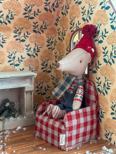 mouse doll sitting in armchair, christmas room, banner, concept of toy store, holiday