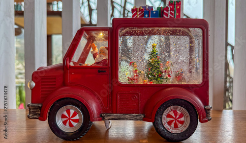 red christmas truck snow globe with santa waving, festive holiday scene, concept of christmas decor, banner