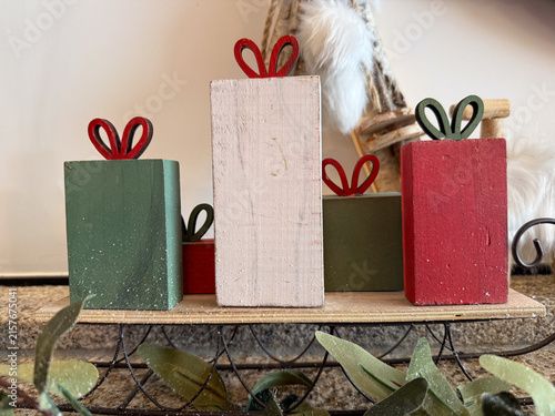 wooden christmas gifts on sled with leaves, holiday decor, banner concept of retail, seasonal sales