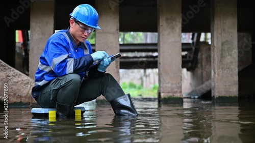Water quality inspector collecting environmental samples from wastewater treatment infrastructure