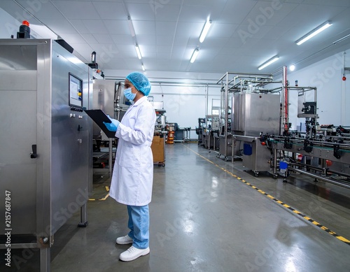 High-tech Indian factory interior featuring precision machinery, organized production systems and engineers overseeing a modern manufacturing process.