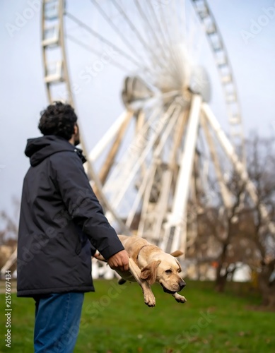 Woman playing with her dog in a park.