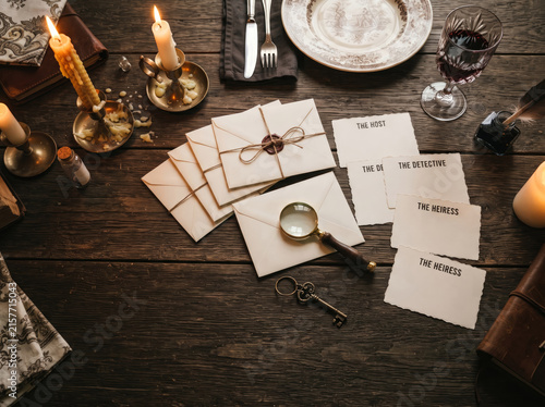Vintage murder mystery dinner party invitation set with wax seals on rustic wooden table