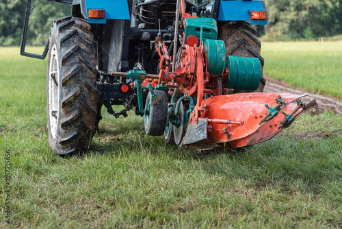 Close up rear view of tractor with mounted plow