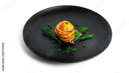 Konstfotografi Baked potatoes with herbs on black plate isolated on a white background