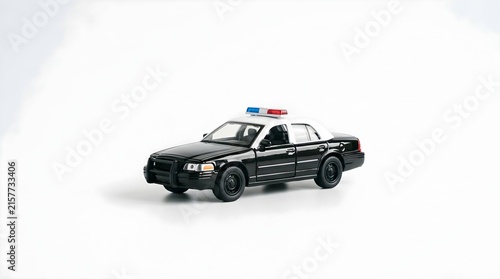 Miniature black and white police car model isolated on white background