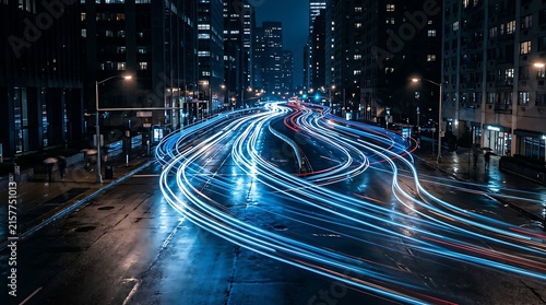 Night city street with long exposure light trails from car traffic moving through a busy road
