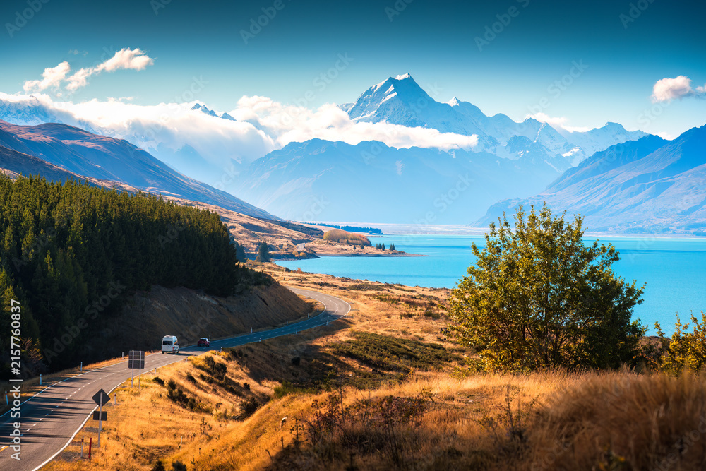 Naklejka premium Scenic Road Trip Winding Road Along Lake Pukaki Under Mount Cook During Autumn in New Zealand