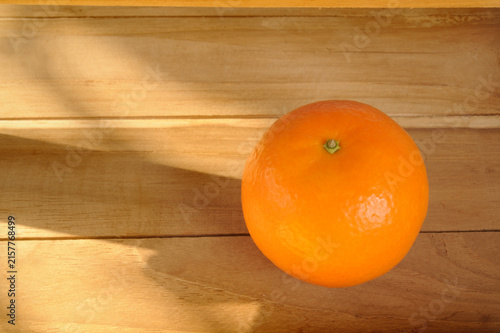 Fresh oranges on a wooden shelf