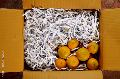 Ripe tangerine oranges packed in a paper box