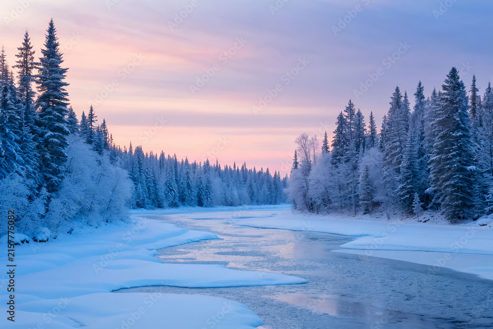 Fototapeta premium Winter landscape with frozen river and snow covered pine forest at sunset 1.