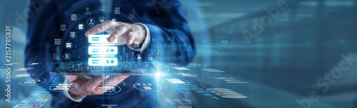 Konstfotografi Web administrator hands holding tablet managing secure cloud Hosting servers in a modern data center