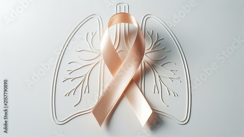 Peach awareness ribbon placed over white relief sculpture of human lungs on bright clean surface