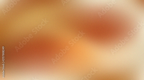 Abstract grainy gradient background with warm orange and beige soft blurred colors.