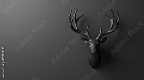 Stylish matte black deer head sculpture with elegant antlers mounted on a dark minimalist wall, offering ample copy space for graphic design and contemporary decor concepts.