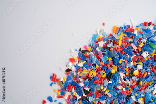 Fotografie Plastic colorful pieces recycling shredded for industrial use.