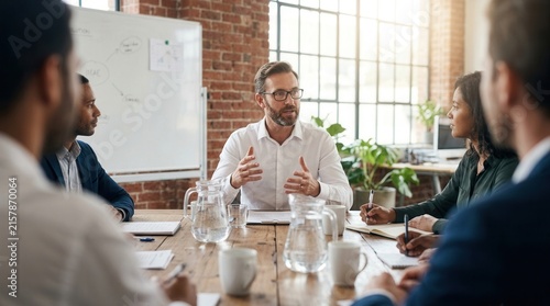Teamwork and leadership during a corporate business seminar in a boardroom with a manager and coworkers.