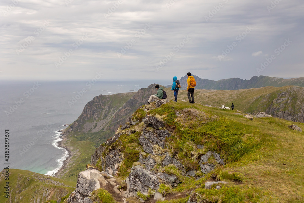 Fototapeta premium Mount Matind hike, family with children and pet dog, hiking Matinden peak summertime