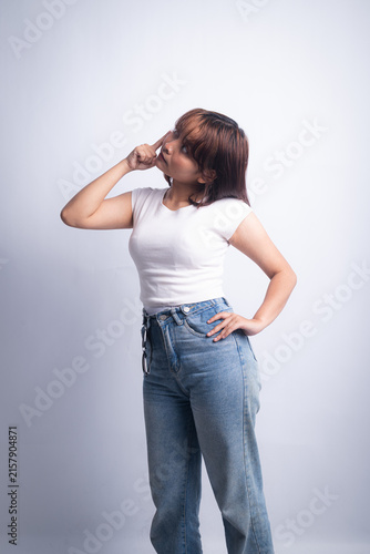 Young woman thoughtful pose in jeans and white t-shirt