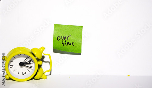 Bild auf Leinwand clock bells and colored paper with the word overtime