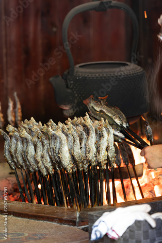 Salted Fish Skewers Grilling Over Charcoal Fire in Japan
