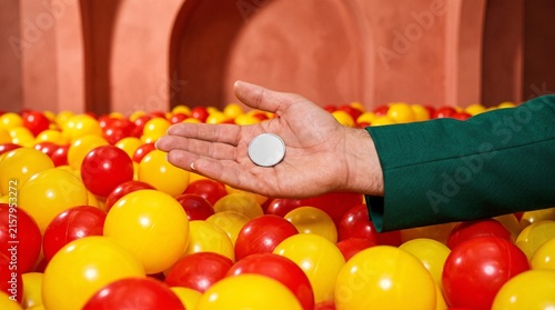 A savings token discovered beneath bright plastic balls