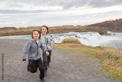 Fotografía Portrait of happy running kids, boy brothers, near smaller waterfall around Gull