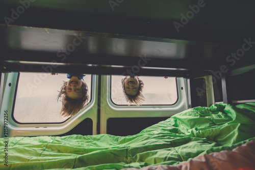Children, having fun in motorhome while heavy raining outdoors, playing and making mischiefs together