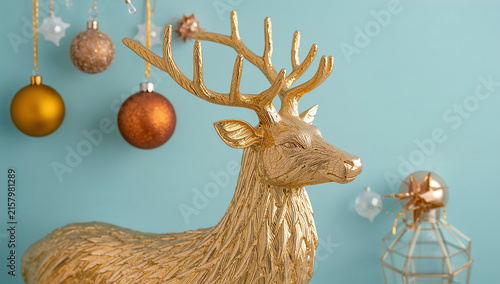 Golden deer figurine decorating a Christmas holiday scene