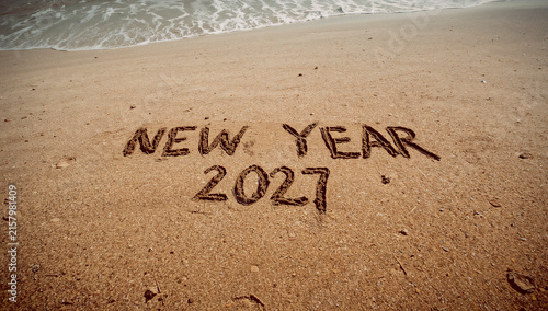 New Year 2027 message written on sandy beach