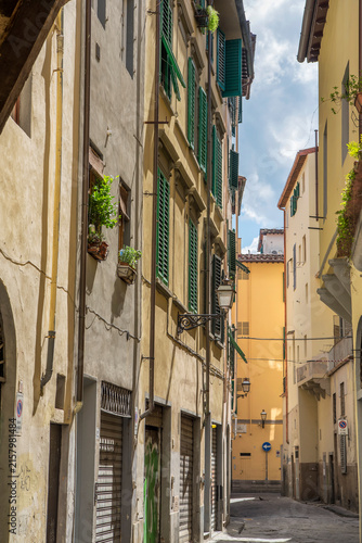 A narrow alleyway in Florence italy on a sunny day.